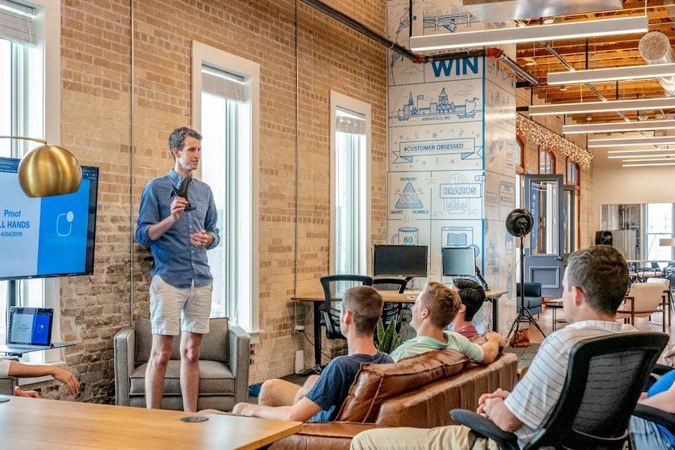 A trainer with a small group in a bright room.