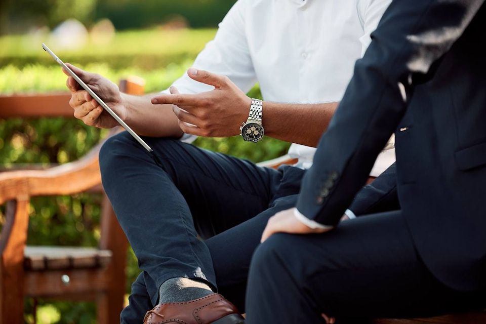 Hands holding a phone with social media on the screen.